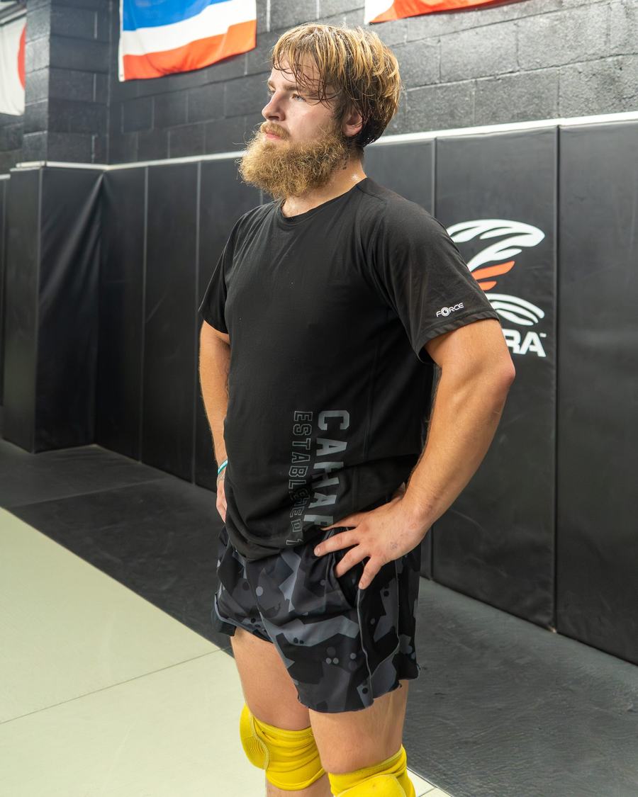 Fighter standing by the padded wall